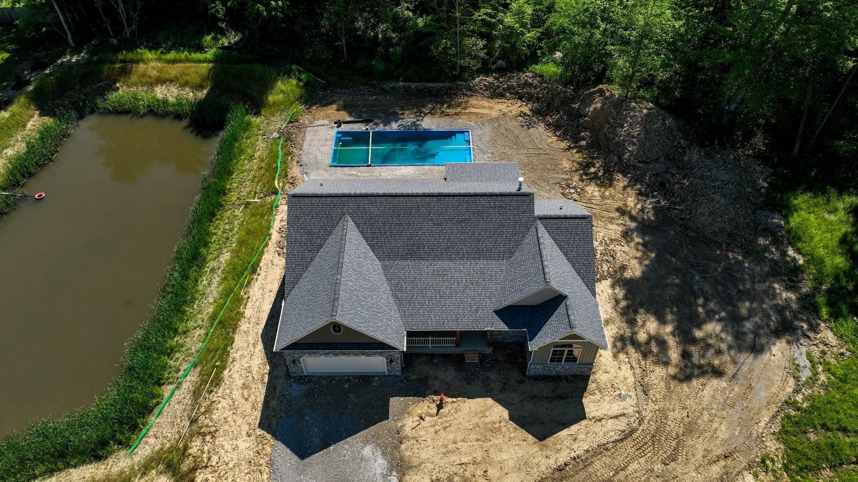 Overhead view of a finished home and its pool