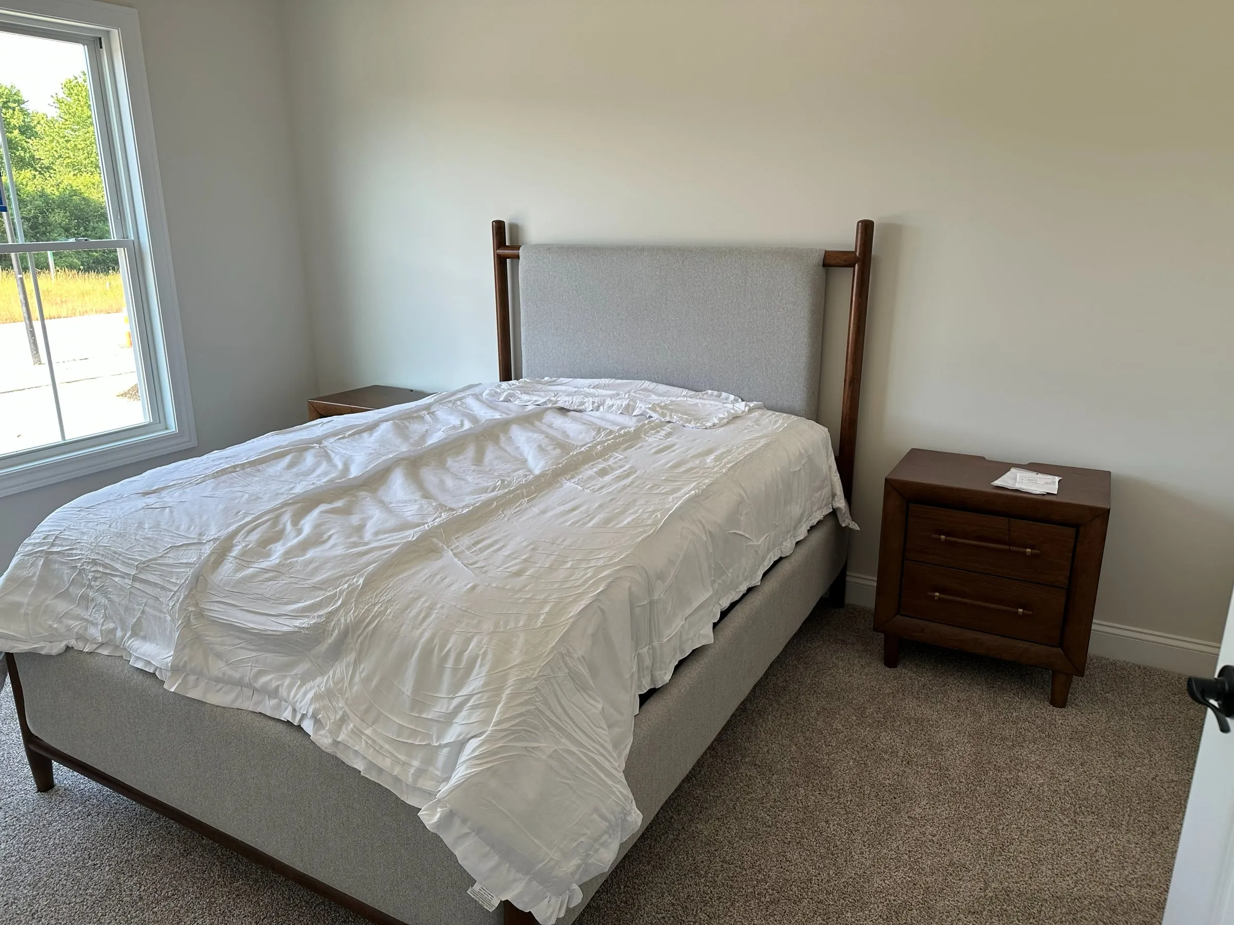 Model home bedroom with an upholstered headboard