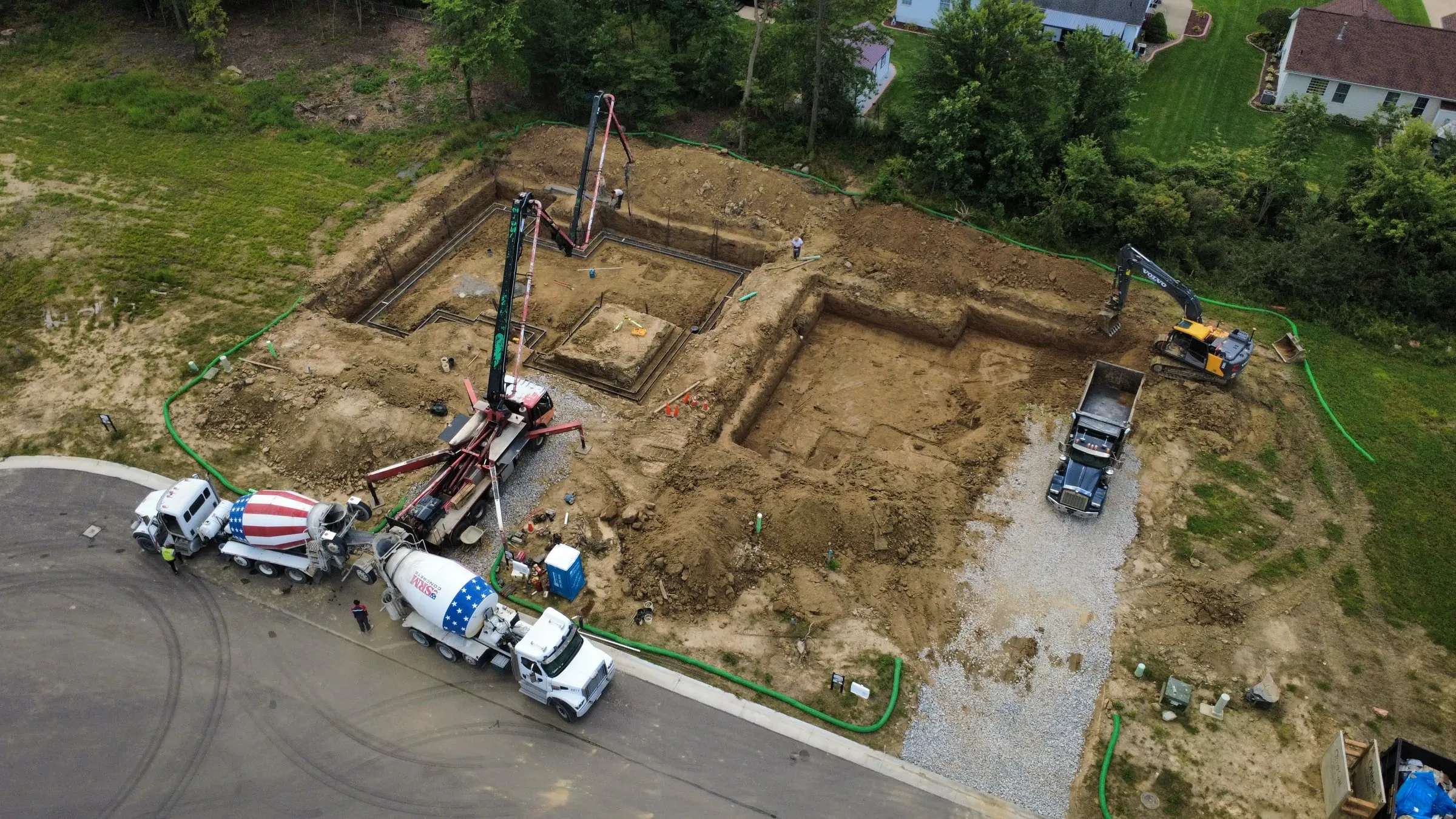 Concrete trucks placing the foundation, seen from above
