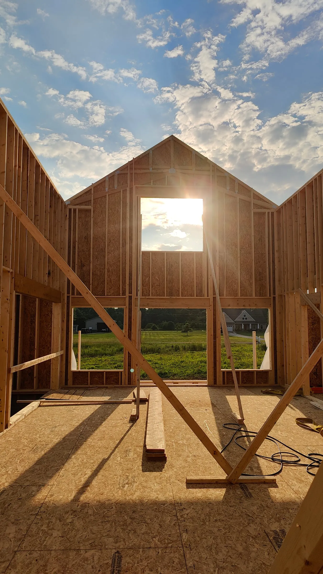 A home being framed against an evening sky