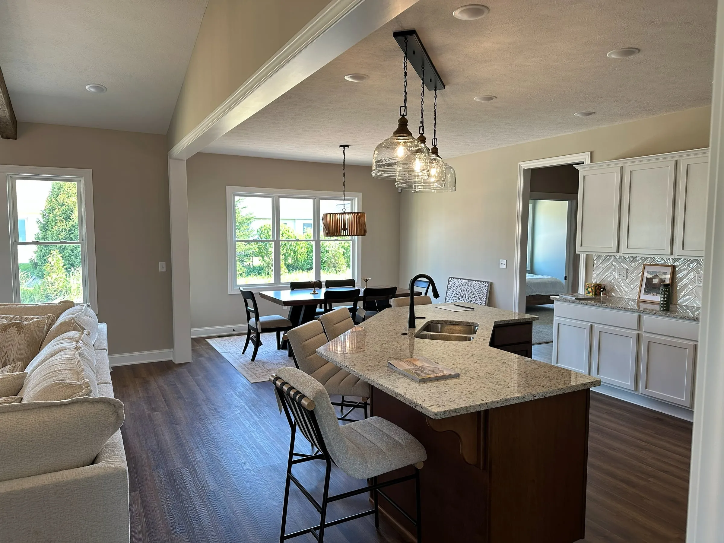 Model home kitchen and dining area under a vaulted ceiling