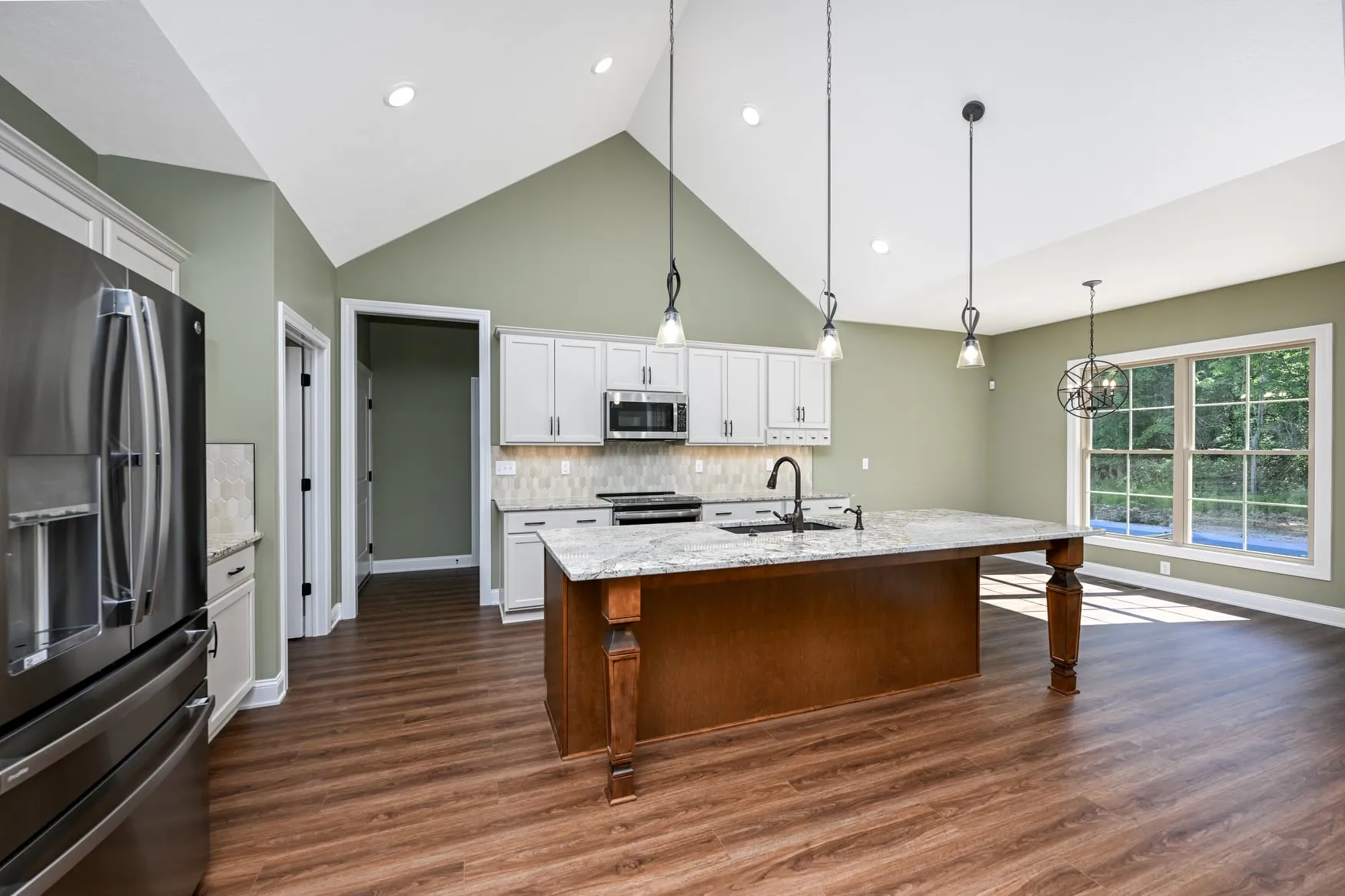 Kitchen with stainless appliances and a granite island