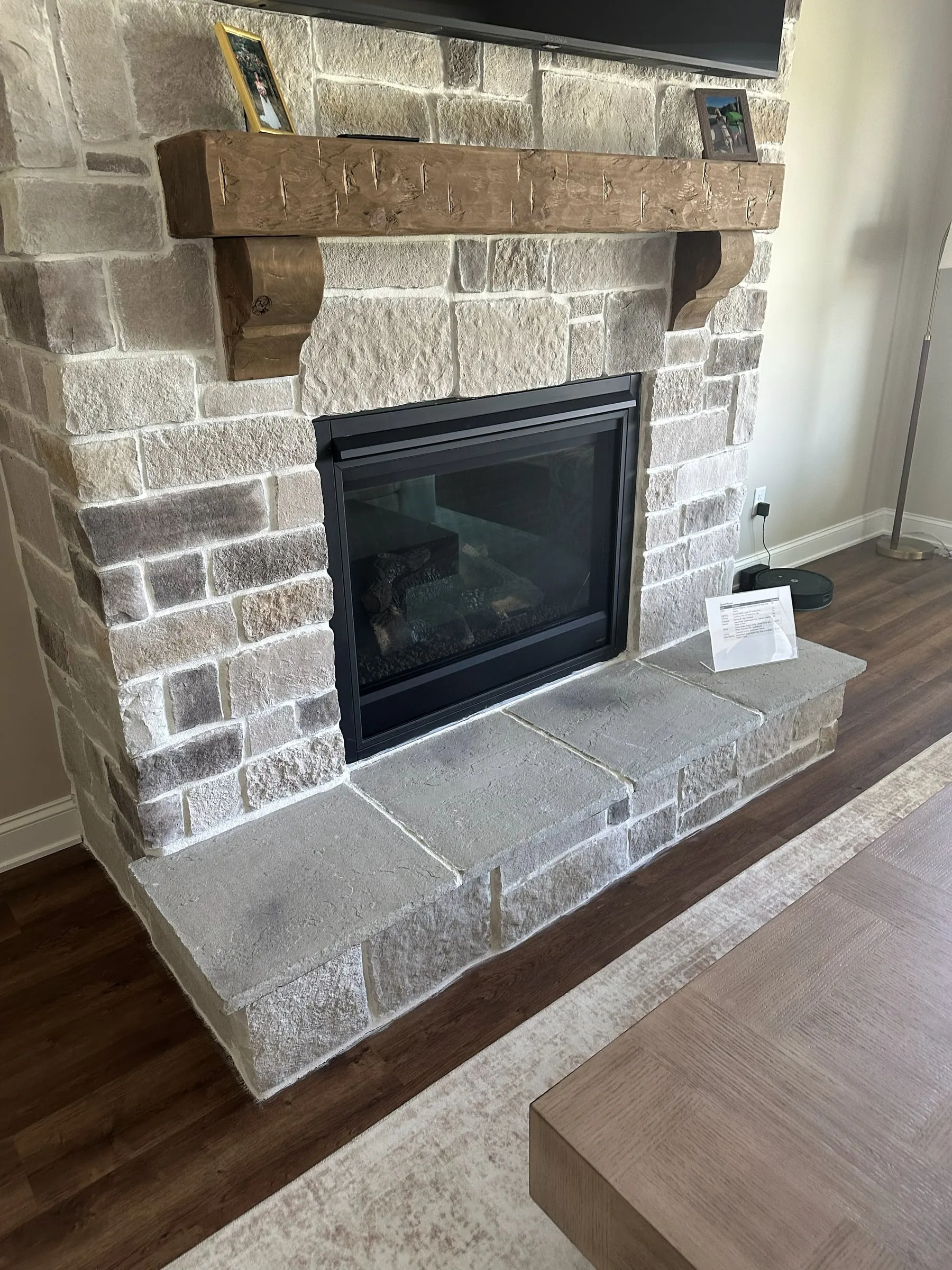 Stone fireplace surround with a poured hearth