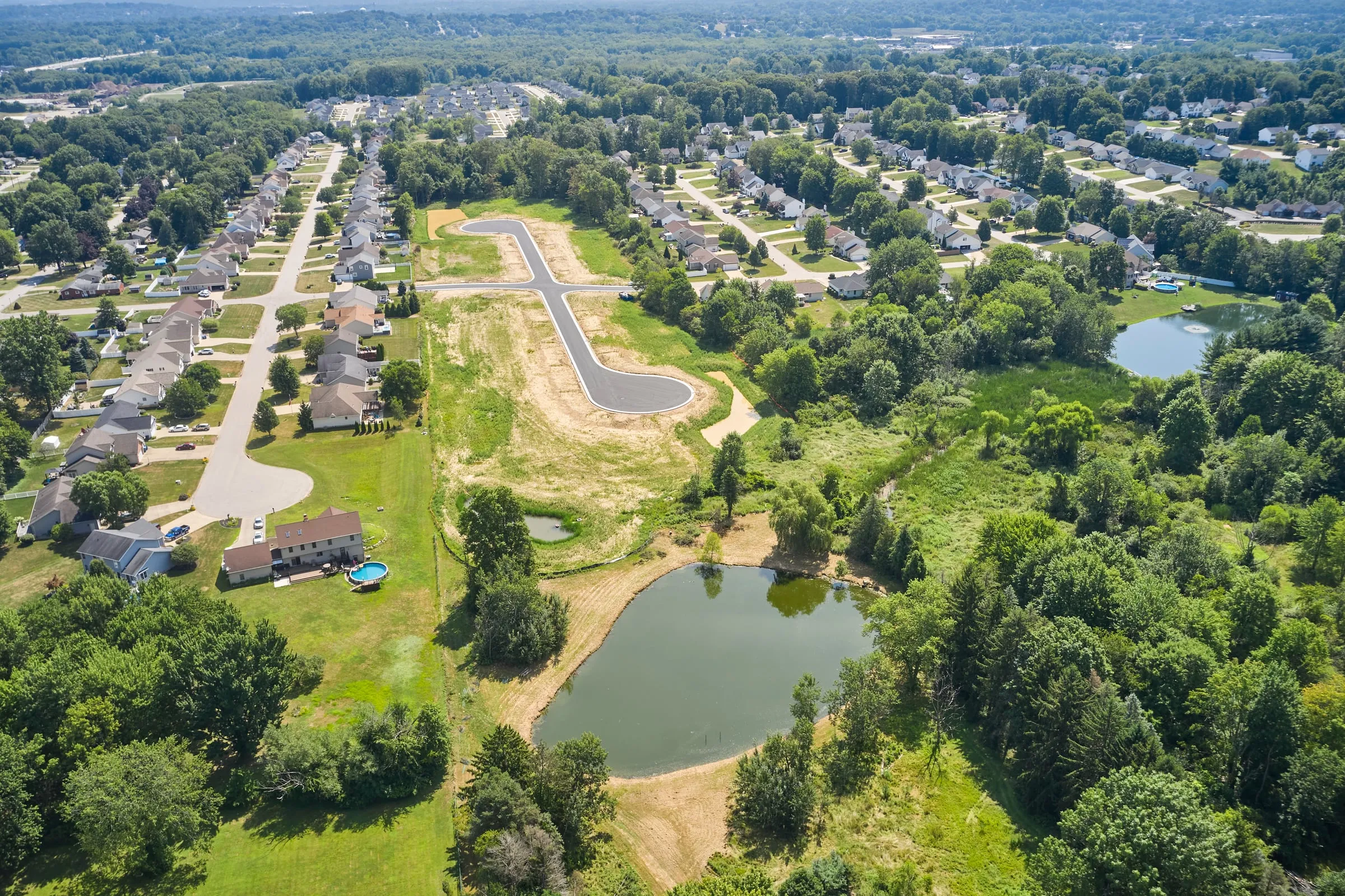 Aerial view of the Willow Run at Norton community with its pond and surrounding forest